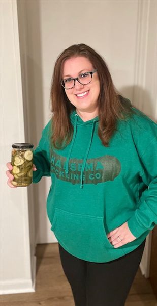 Kim, longtime friend of the family, holding a jar of pickles